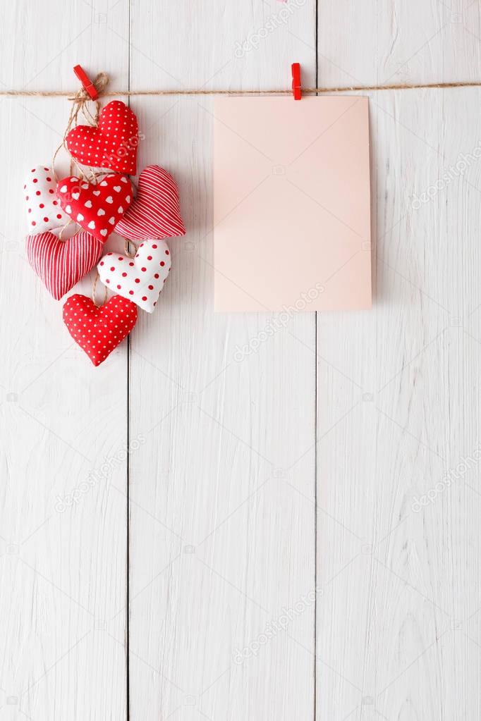 Valentine day background, pillow hearts and card on wood