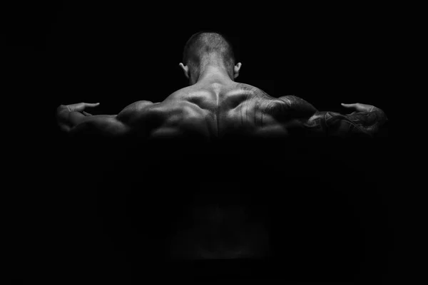 Unrecognizable man shows strong back muscles closeup — Stock Photo, Image