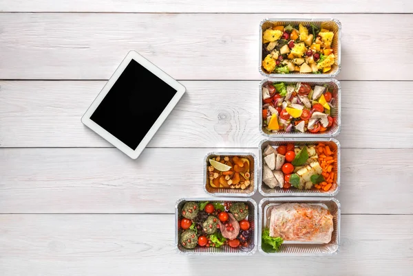 Healthy food online order in boxes, top view at wood