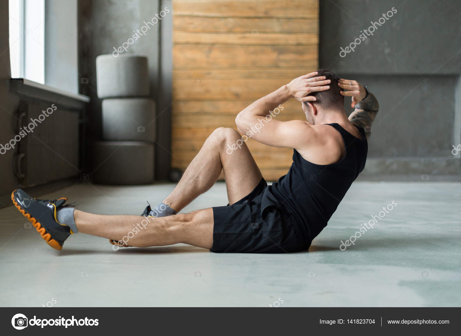 Young man fitness workout cross crunches for abs Stock Photo by