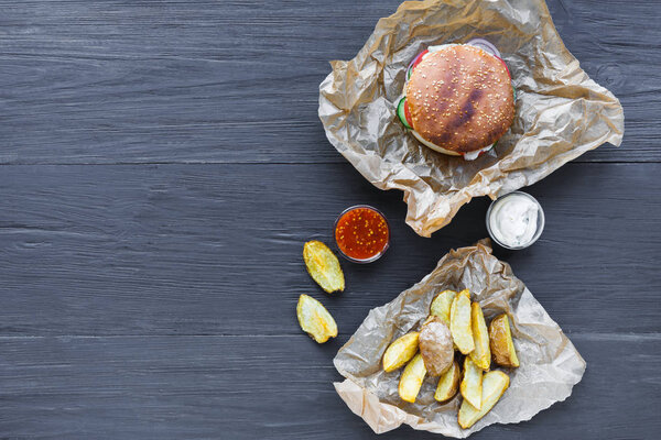 Fast food restaurant dish. Hamburger and potato wedges