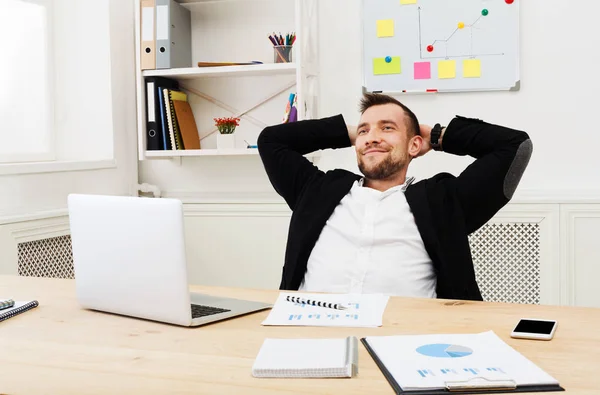 Giovane uomo d'affari rilassato con computer portatile in ufficio bianco moderno — Foto Stock