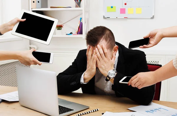 Young stressed overworked businessman in modern office — Stock Photo, Image