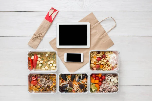 Healthy food online order in boxes, top view at wood