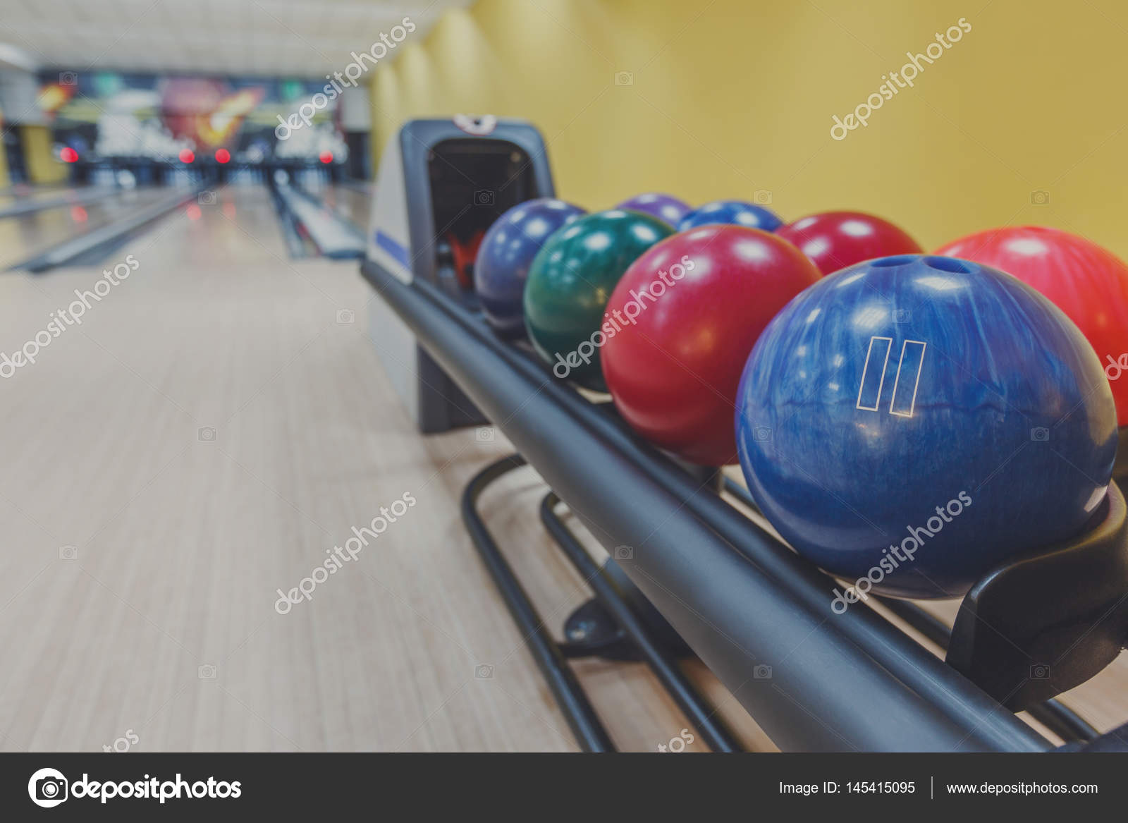 Bowling balls return machine, alley background Stock Photo by ©Milkos