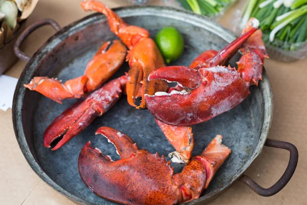 Plenty of seafood, roasted lobster claws on grill pan