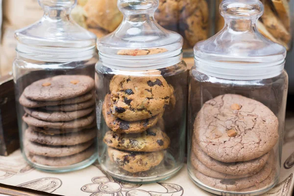 Cookies and biscuits in glass jars on bar for sale — Stock Photo, Image