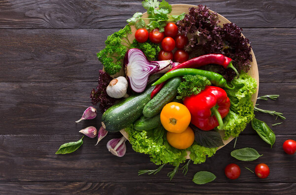 Plenty of fresh vegetables on wooden background with copy space