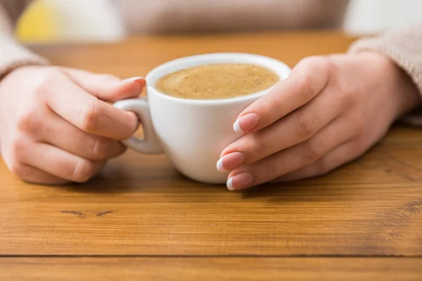 Primo piano di donna con tazza di caffè in caffè — Foto Stock