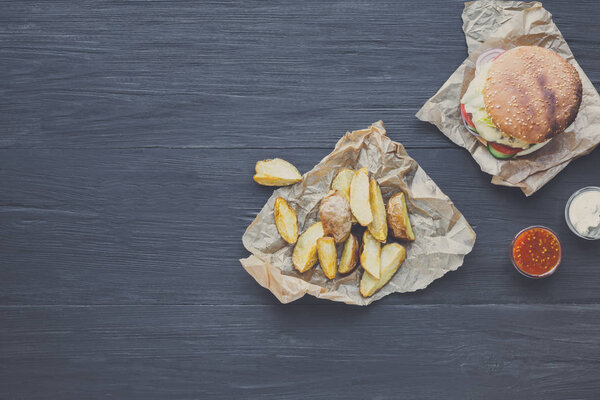 Fast food restaurant dish. Hamburger and potato wedges