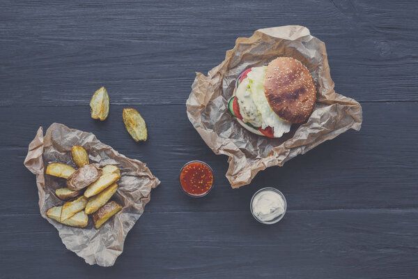 Fast food restaurant dish. Hamburger and potato wedges