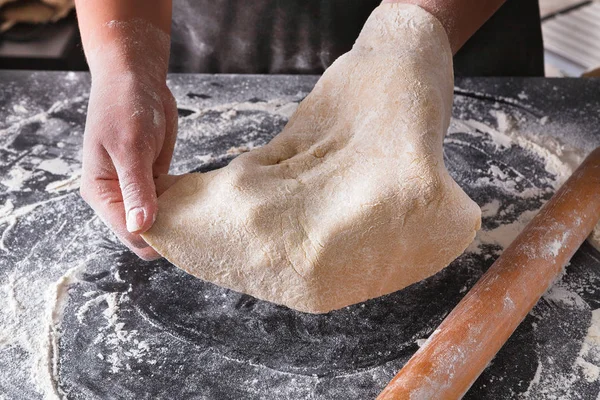 Baking concept. Hands roll dough on black background. — Stock Photo, Image