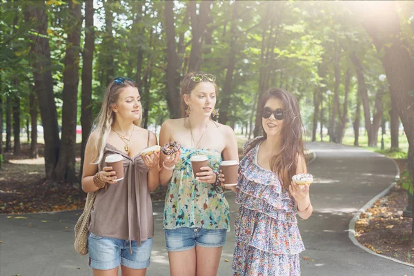 Three beautiful young boho chic stylish girls walking in park. — Stock Photo, Image