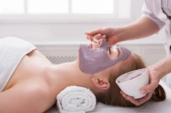 Жінка отримує маску для обличчя від косметолога в спа — стокове фото
