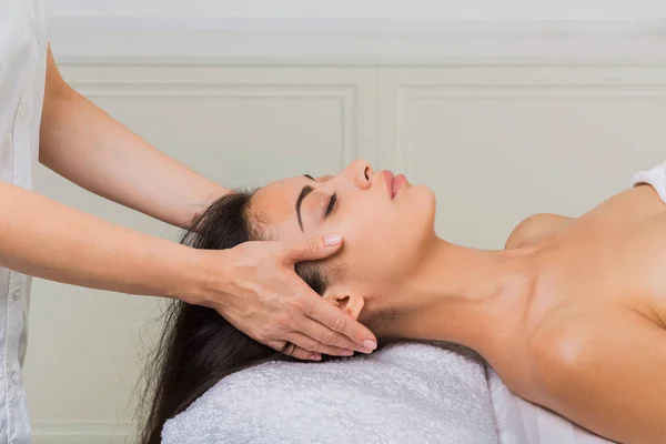 Woman massagist make face lifting massage in spa wellness center — Stock Photo, Image