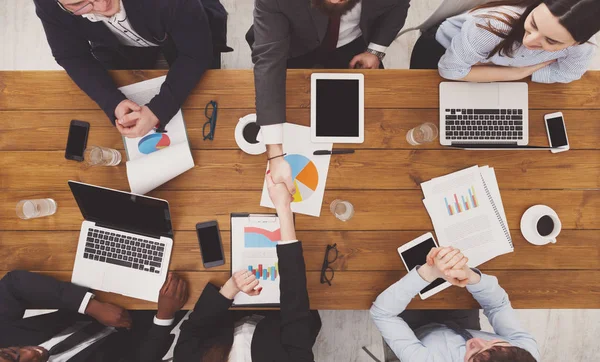 Business people group handshake in office, top view — Stock Photo, Image