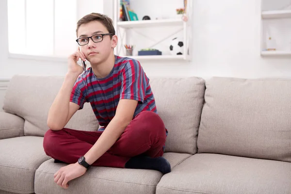 Teenager has phone talk in living room at home