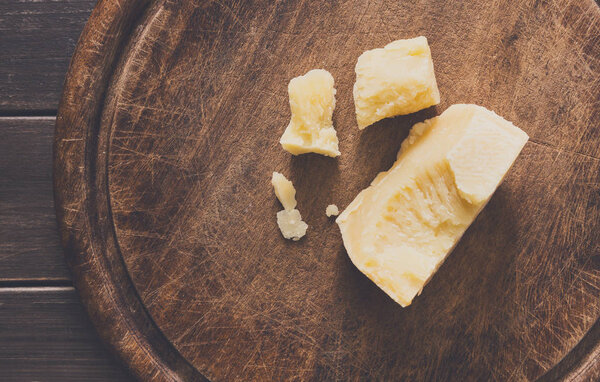 Cheese delikatessen on rustic wood desk, parmesan