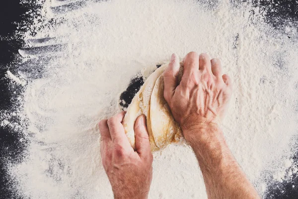 Hands top view knead dough on black background — Stock Photo, Image