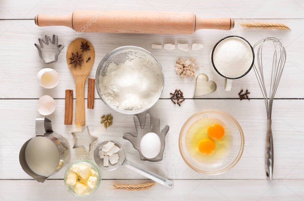 Baking flat lay ingredients on white rustic wood background
