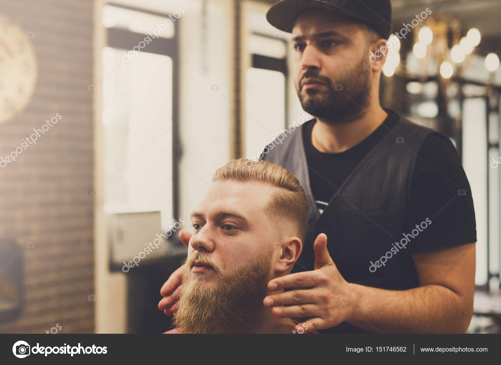 Man Getting Haircut By Hairstylist At Barbershop Stock Photo