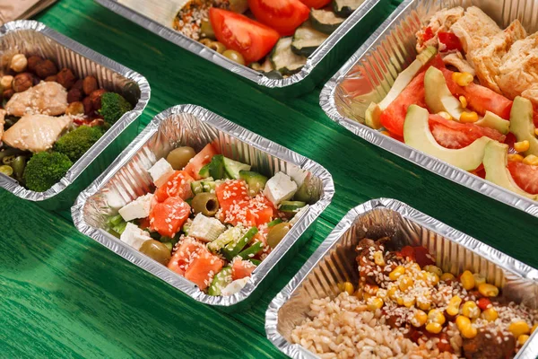 Healthy food take away in lunch boxes at green wood