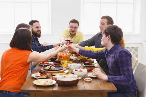 People say cheers clink glasses at festive table dinner party — Stock Photo, Image