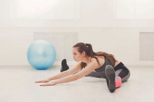 Mujer fitness en el entrenamiento de estiramiento en interiores — Foto de Stock
