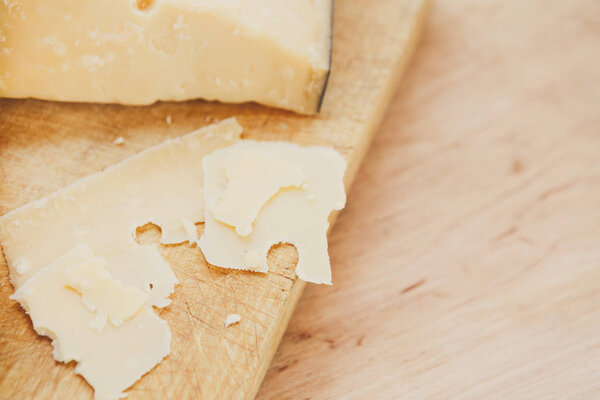 Cheese platter, parmesan on natural wooden board