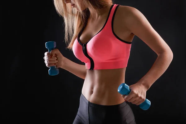 Fitness model woman with dumbbells at studio — Stock Photo, Image