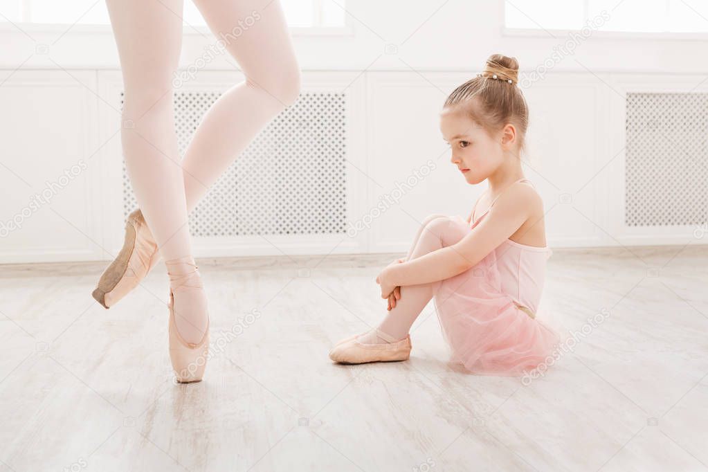 Little girl looking at professional ballet dancer
