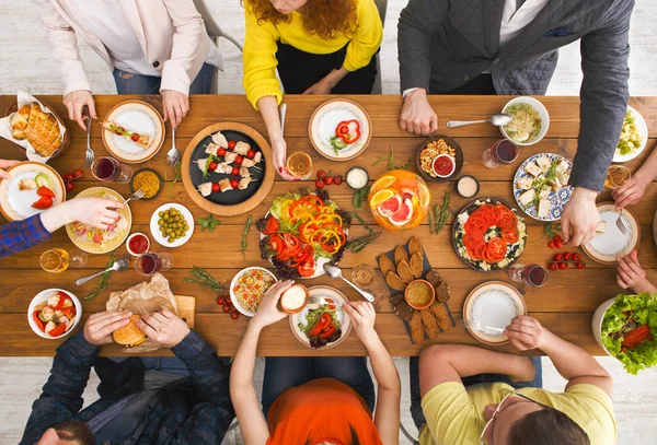 Mensen eten gezonde maaltijden op tafel geserveerd diner — Stockfoto