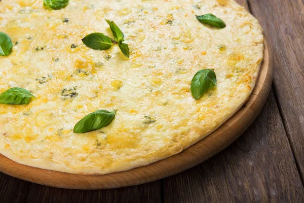 Delicious four cheese pizza with basil leaves — Stock Photo, Image