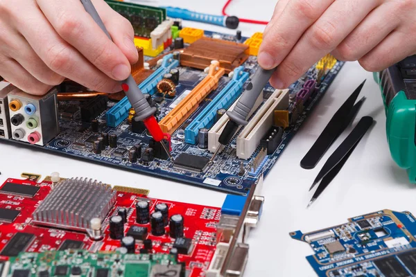 Ingenieur moederbord met de multimeter controleren — Stockfoto