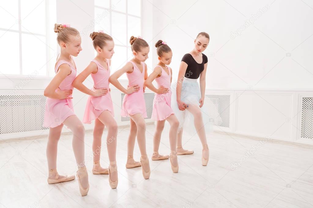 Teacher helping her students during dance class
