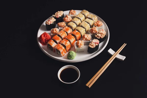 サーモン寿司と黒い背景、pov ビューにロールのセット — ストック写真