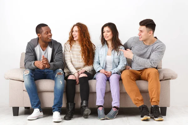 Happy young friends, casual people sitting on couch