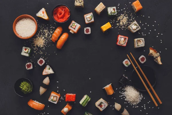 Sushi and rolls background, frame on black, top view. — Stock Photo, Image
