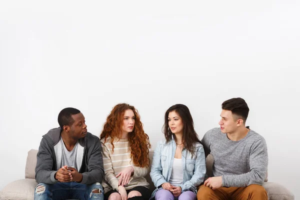 Happy young friends, casual people sitting on couch