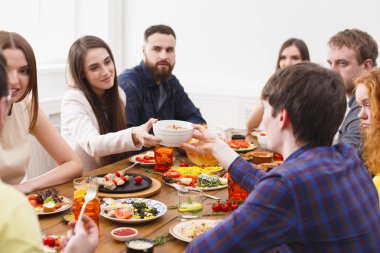 Group of happy people at festive table dinner party clipart