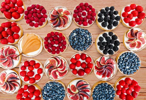 Fruit and Berry tarts dessert assorted top view background — Stock Photo, Image