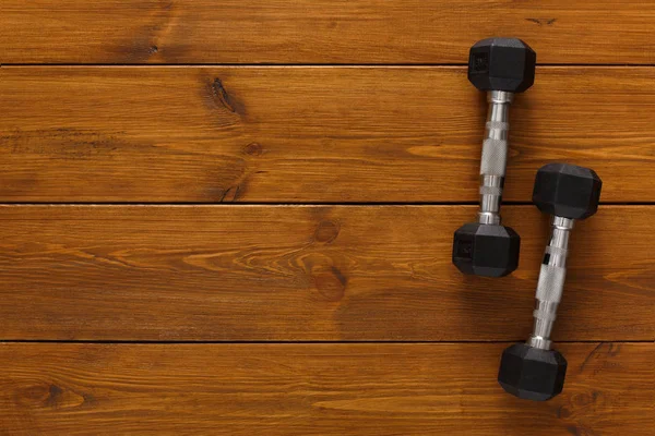 Two dumbbells on wooden background copy space — Stock Photo, Image