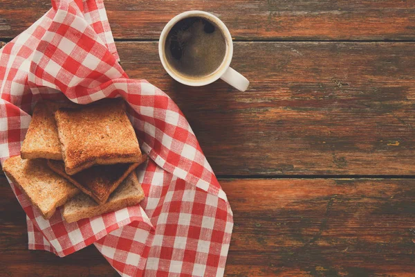 Breakfast background, toast and coffee on rustic wood, top view