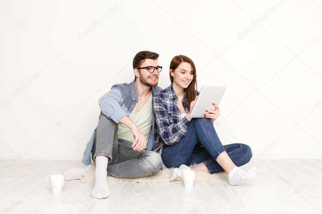 Couple ordering purchase with digital tablet