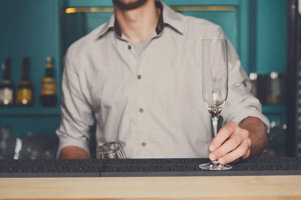 Barman com copo de champanhe vazio no bar — Fotografia de Stock