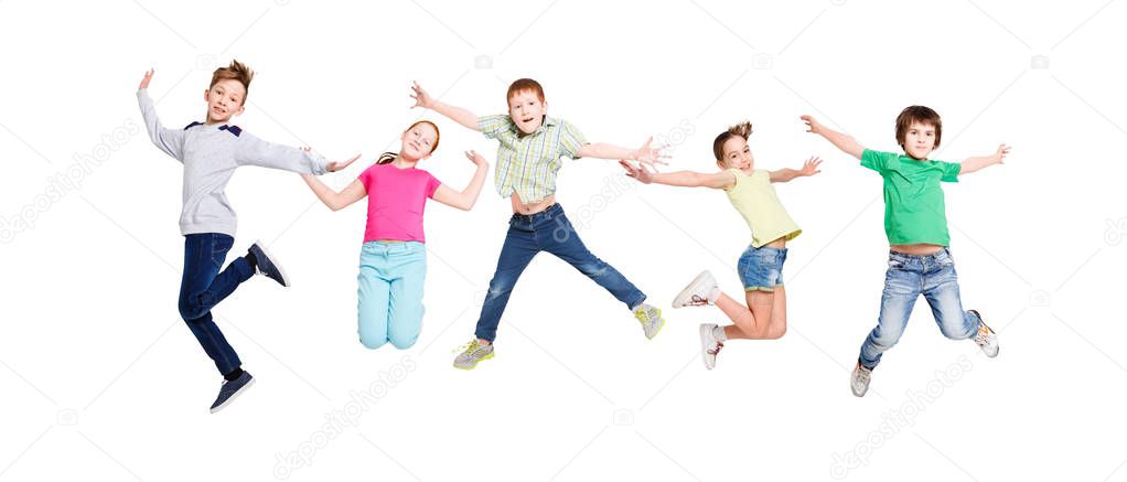 Happy kids jumping at studio, copy space