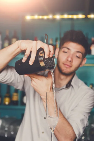 Jonge barman cocktail drinken in glas gieten — Stockfoto