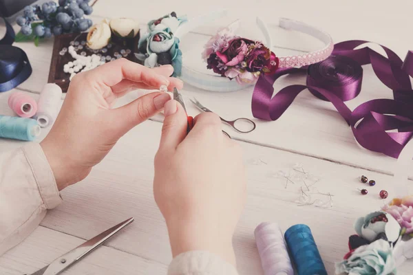 Master making handmade jewelry, woman pov