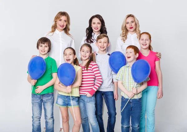 Happy kids and adults standing at white background, copy space — Stock Photo, Image