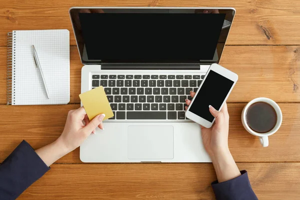 Woman using laptop in coffee shop, close-up, top view — Stock Photo, Image